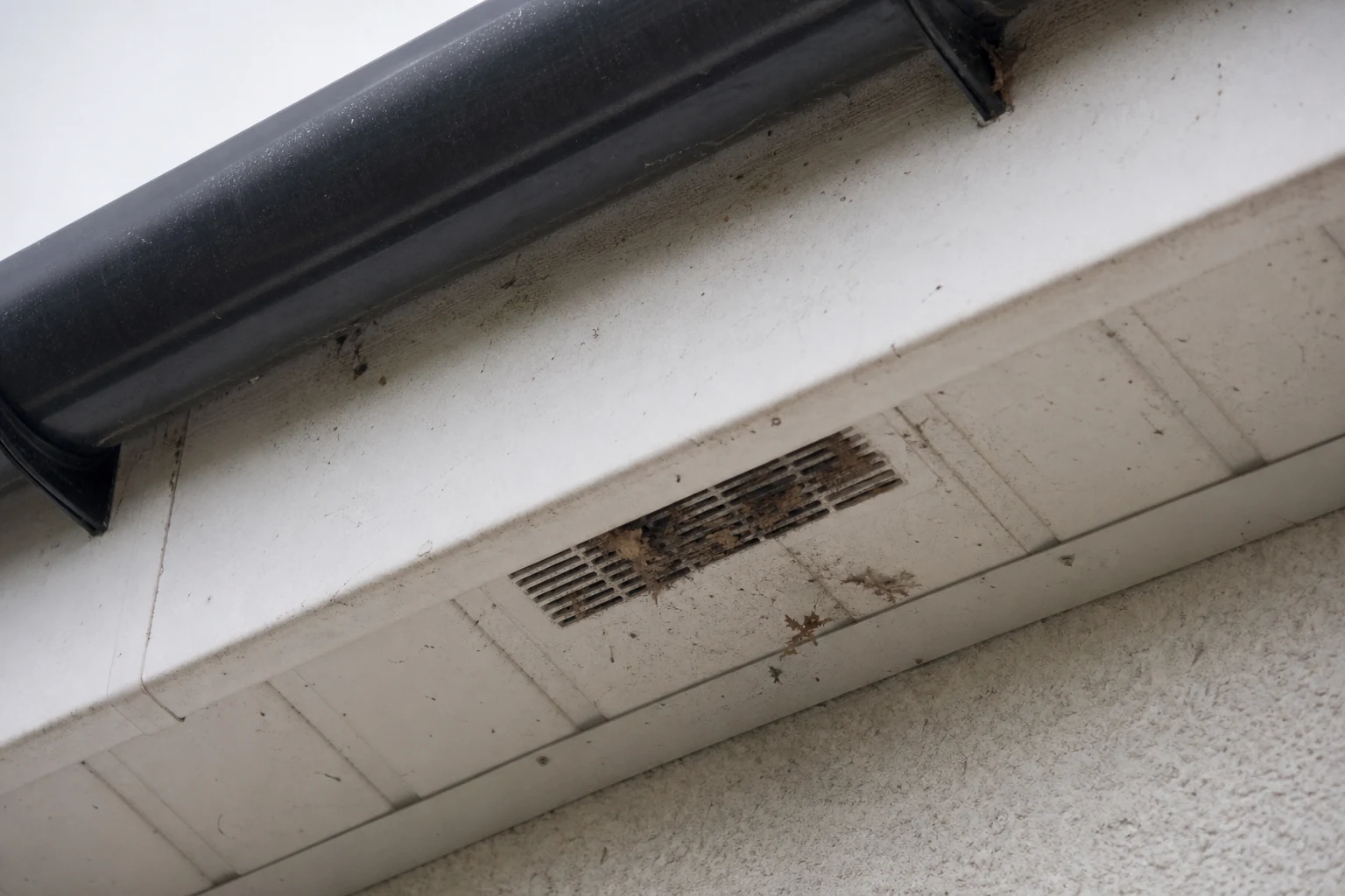 Partly blocked soffit vent under a roof edge