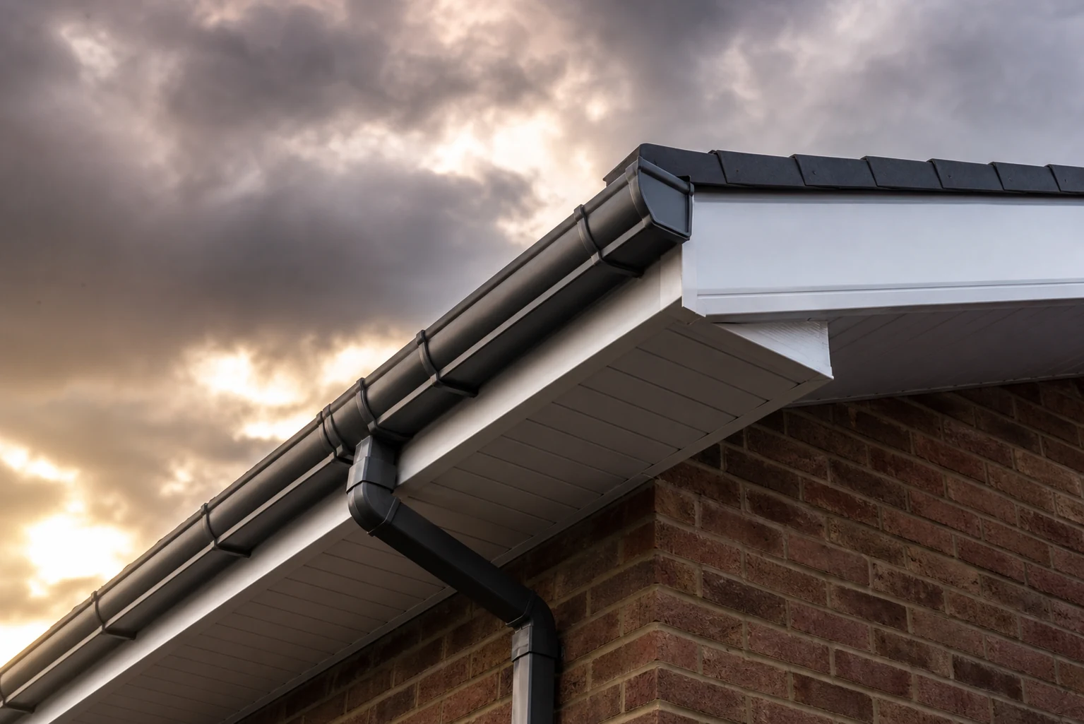 Well maintained soffit fascia and gutter along a roof edge