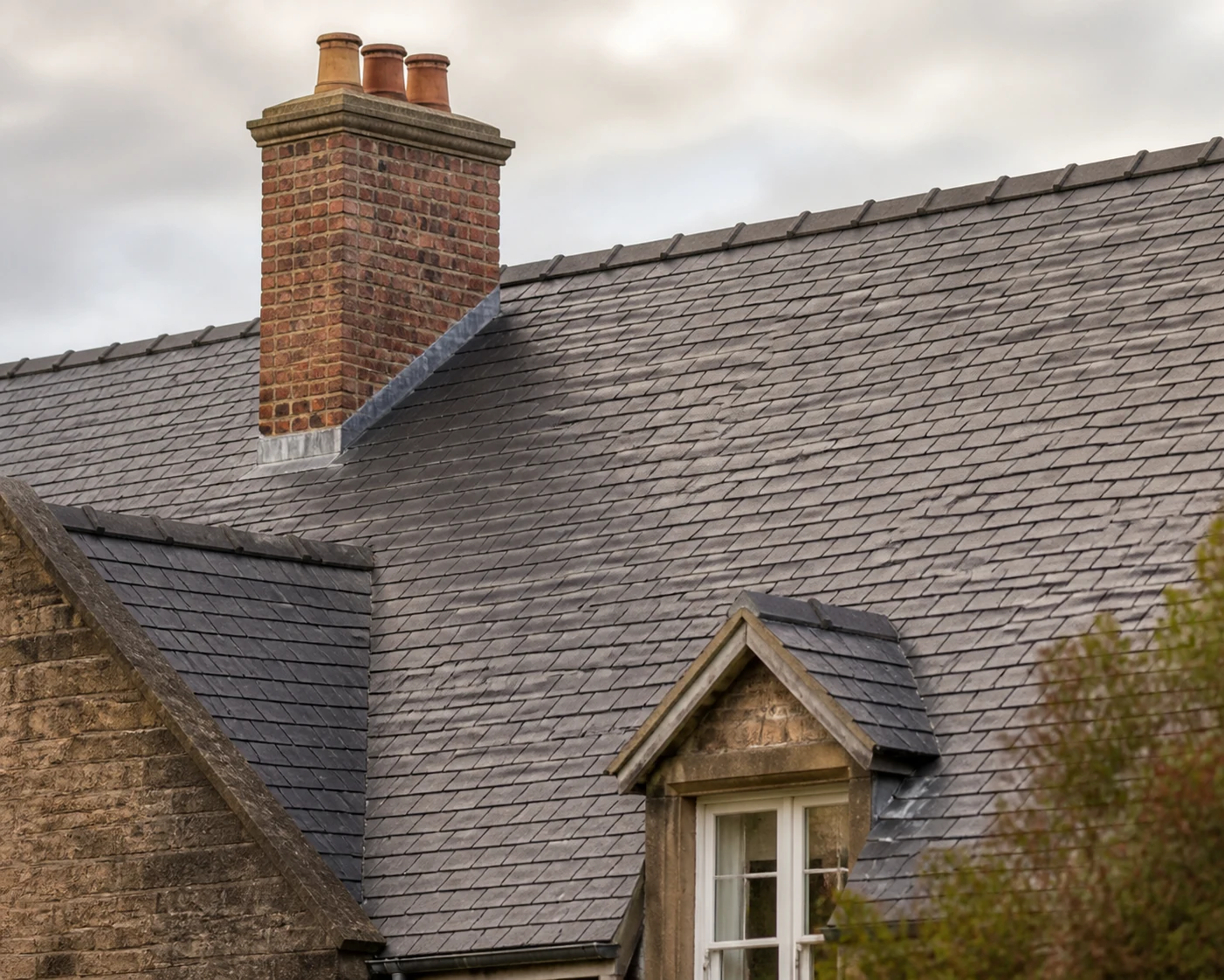 Restored traditional slate roof with chimney and lead flashing